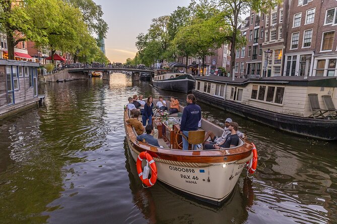 Amsterdam 2 Hour Small-Group Canal Cruise with Dutch Snacks & Bar - Amstel River and Magere Brug: romance, bridges, and real photo odds