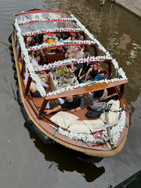 Amsterdam: Boat Tour with Optional Unlimited Drinks - The Enterprise Boat: Open Deck Views and a Glass-Roof Shelter