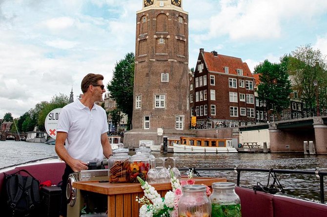 Amsterdam canal cruise in open boat – Guided tour - On-board vibe: electric boat comfort, drinks, and hearing the guide