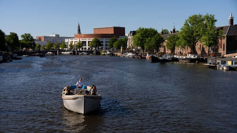 Amsterdam: Canal Cruise in Open Boat with Drink Option - Live commentary: how the guide turns the canal names into a story