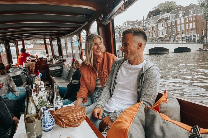 Amsterdam Classic Saloon Boat Cruise with Drinks and Cheese - Seats, sound, and photo reality on a 46-person enclosed boat