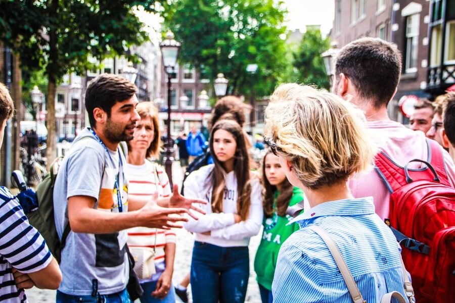 Amsterdam full day tour: Walking, Biking & Cruising - The canal cruise finish at Prins Hendrikkade: glass-roof views and audio in 17 languages