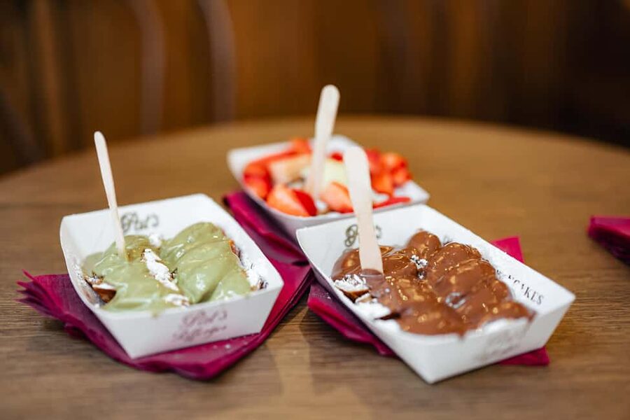 Amsterdam: Guided Cultural Food Tour in English or German - The city-walk format, stops that combine story and sight