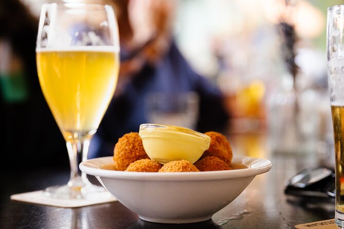 Amsterdam High-End Dutch Food & History Tour - Up to 8 guests - Fish shop stop: herring, fried cod, and smoked eel