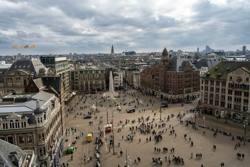 Amsterdam: Iconic Canals & Historic Sights Walking Tour - Dam Square and the Royal Palace, the city’s public front door