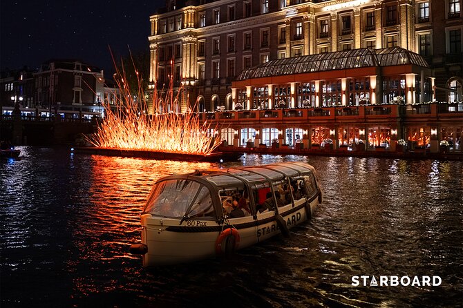 Amsterdam: Light Festival Cruise with Unlimited Drinks Option - Amsterdam Central Station from the water: big, dramatic, different