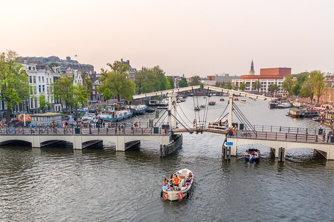 Gabled houses and arched bridges along an Amsterdam canal