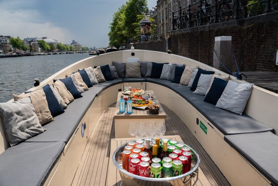 Amsterdam: Private Canal Booze Cruise with Unlimited Drinks - Meeting at Amstel 178, then getting comfy fast