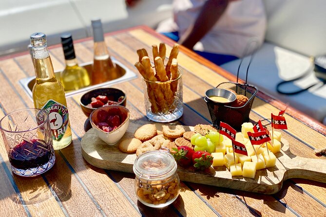 Amsterdam Small-Group Canal Cruise Including Snacks and Drinks - Comfort on chilly canal days: open-air views with practical cover