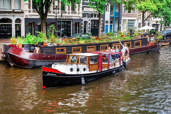 Amsterdam Small-Group Canal Cruise With Dutch Snacks and Drink - The long-canals loop, bridges, flea market area, and older Amsterdam edges