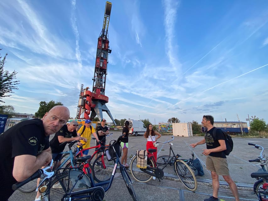 Amsterdam: Urban Bike Tour, Graffiti Art & Magnet Fishing - Entering the shipyard world at NDSM, by bike and ferry