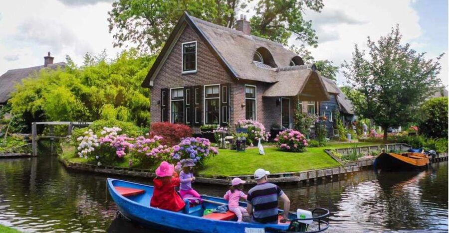 From Amsterdam: Giethoorn Guided Day Trip with Canal Cruise - From Amsterdam to Giethoorn: The Coach Ride With Real Stories