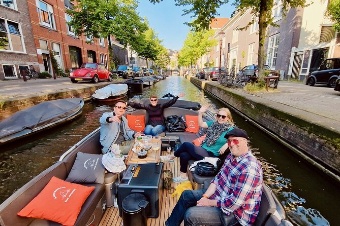 Private 90 Minute Amsterdam Canal Belt Exploration Cruise - Open boat basics: rain canopy, blanket, and life vests