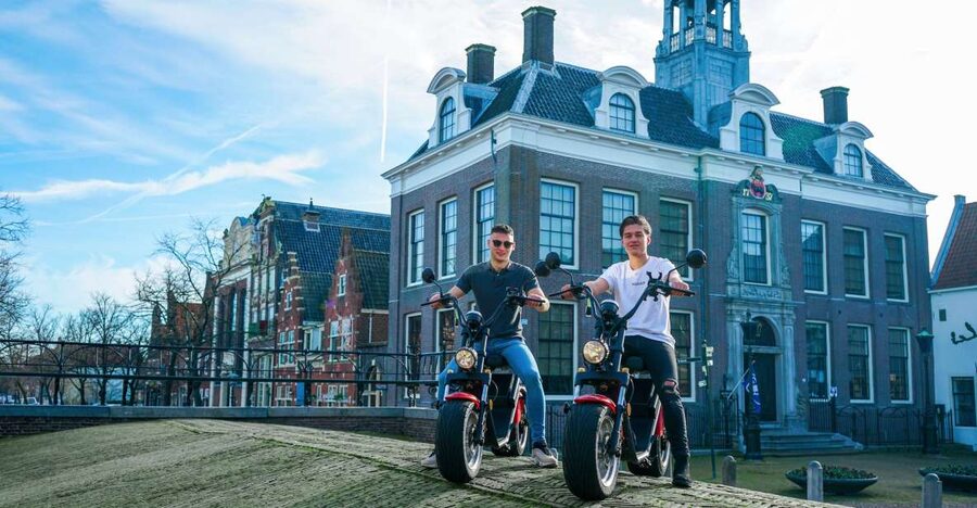 Volendam: E-Scooter Rental - Monnickendam nearby: light bronze brick houses and an old harbor mood
